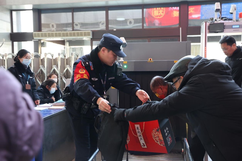 民警为老年旅客搬拿行李。王琴摄