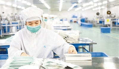 　　西港特區的一家醫用制品生產廠內，工人在包裝一次性醫用口罩。本報記者 趙益普攝
