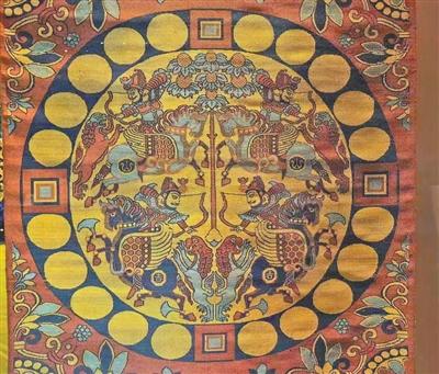 唐代“红地联珠团窠四骑士狩猎纹锦”(复制件)。